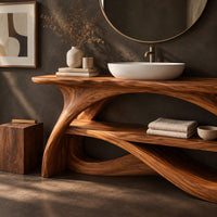 Corner detail of long slab top on swooping branch like legs with a lower wooden shelf beside wood, brass and linen samples