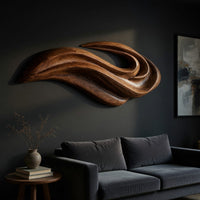 Layered swoosh carved wooden wall sculpture, three-quarter view showing the carved depth