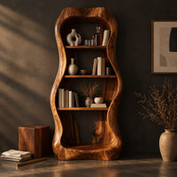 Corner detail of tall bar cabinet with a thick wavy frame and open shelves beside wood, brass and linen samples