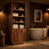 Tall bathroom cabinet with four open shelves above two small drawers and two doors in an evening bathroom with walnut wall paneling