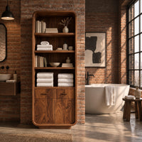 Tall bathroom cabinet with four open shelves above two small drawers and two doors in an industrial loft bathroom with exposed brick