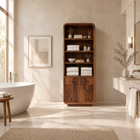 Tall bathroom cabinet with four open shelves above two small drawers and two doors in a bright open plan bathroom