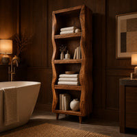 Tall narrow cabinet with wavy side panels and four open shelves in an evening bathroom with walnut wall paneling