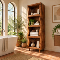 Tall narrow cabinet with wavy side panels and four open shelves in a bright bathroom with arched windows and plants