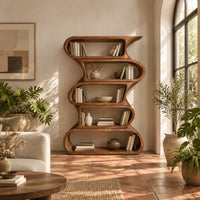Tall bookshelf made of five stacked open wavy loop tiers in a bright living room with arched windows and plants
