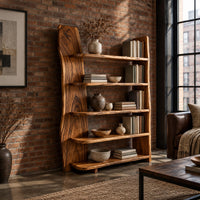 Bookshelf with five shelves and a tall slab side with a wavy outline in an industrial loft living room with exposed brick