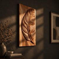 Tall wood panel carved in deep relief with one large leaf and fine veins, three-quarter view showing the carved depth