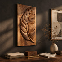 Detail of tall wood panel carved in deep relief with one large leaf and fine veins beside wood, brass and linen samples