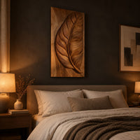 Tall wood panel carved in deep relief with one large leaf and fine veins above a bed in a dusk lit bedroom