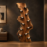 Tall live edge slab wine rack with angled bottle pegs in a dark studio against a charcoal plaster wall