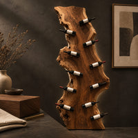 Corner detail of tall live edge slab wine rack with angled bottle pegs beside wood, brass and linen samples