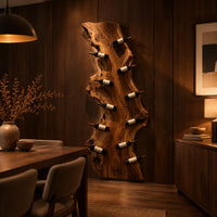 Tall live edge slab wine rack with angled bottle pegs in an evening dining room with walnut wall paneling