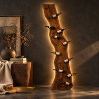 Corner detail of tall wine rack made from a live edge slab with staggered pegs beside wood, brass and linen samples