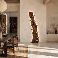 Tall wine rack made from a live edge slab with staggered pegs in a bright open plan dining room