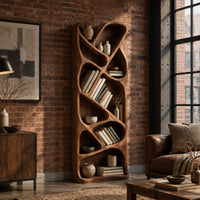 Tall narrow wooden bookshelf with slanted dividers and flowing open cubbies in an industrial loft living room with exposed brick