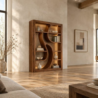 Tall open bookshelf with a sculpted s shaped divider between shelves in a bright open plan living room