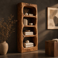 Corner detail of tall open shelf cabinet with four carved niches and textured grain beside wood, brass and linen samples