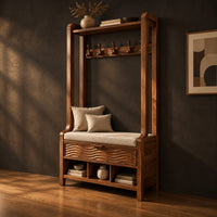 Tall wood storage bench with coat hooks and three open cubbies, three-quarter view showing the grain