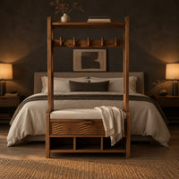 Tall wood storage bench with coat hooks and three open cubbies in a dark bedroom at golden hour