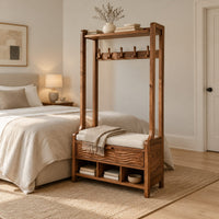 Tall wood storage bench with coat hooks and three open cubbies in a Scandinavian bedroom with white walls