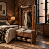 Tall wood storage bench with coat hooks and three open cubbies in an industrial loft bedroom with exposed brick