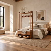 Tall wood storage bench with coat hooks and three open cubbies in a bright open plan bedroom