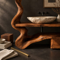 Corner detail of vanity with a twisting trunk post, slab top and low cabinet block beside wood, brass and linen samples