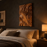 Tall wood wall art panel with sculpted ripples and a ringed knot above a bed in a dusk lit bedroom