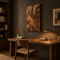 Tall wood wall art panel with sculpted ripples and a ringed knot above a desk in a dark study corner