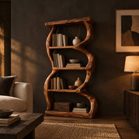 Tall bookshelf with wavy sides, four open shelves and a thick organic frame in a dark living room at golden hour