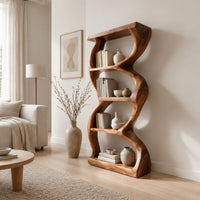 Tall bookshelf with wavy sides, four open shelves and a thick organic frame in a Scandinavian living room with white walls