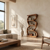 Tall bookshelf with wavy sides, four open shelves and a thick organic frame in a bright open plan living room