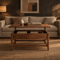 Lift top coffee table with tapered legs and a lower rail frame in a dark living room at golden hour