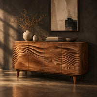 Sideboard with four wave carved doors and tapered legs, three-quarter view showing the grain