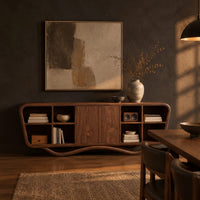 Tapered sideboard with open cubbies on both sides and a wavy base in a dark dining room at golden hour