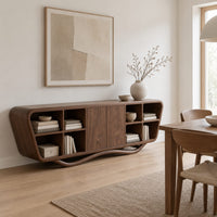 Tapered sideboard with open cubbies on both sides and a wavy base in a Scandinavian dining room with white walls