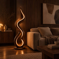 Floor lamp made of one flowing ribbon that ends in a teardrop loop in an evening living room with walnut wall paneling