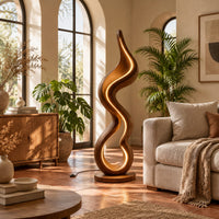 Floor lamp made of one flowing ribbon that ends in a teardrop loop in a bright living room with arched windows and plants