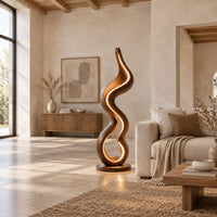 Floor lamp made of one flowing ribbon that ends in a teardrop loop in a bright open plan living room