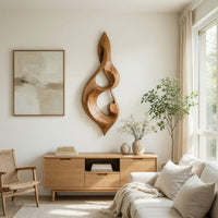 Twisted teardrop note wall sculpture in wood above a light oak sideboard in daylight