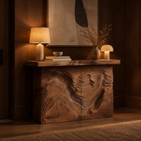 Console table with deep ridged terrain carving across the front in an evening entryway with walnut wall paneling
