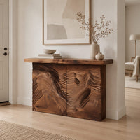 Console table with deep ridged terrain carving across the front in a Scandinavian entryway with white walls