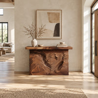 Console table with deep ridged terrain carving across the front in a bright open plan entryway