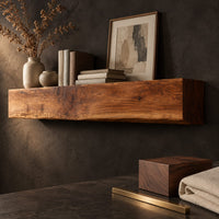 Corner detail of thick wooden beam mantel shelf with a wavy natural top edge beside wood, brass and linen samples