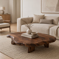 Low coffee table with a thick live edge slab top on short chunky legs in a Scandinavian living room with white walls