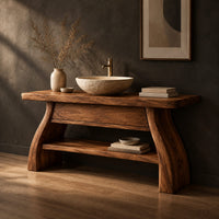 Freestanding vanity with a thick slab top, flared legs and a low shelf, three-quarter view showing the grain
