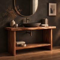 Corner detail of bathroom vanity with a thick slab top, plank legs and a low shelf beside wood, brass and linen samples