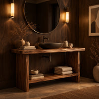 Bathroom vanity with a thick slab top, plank legs and a low shelf in an evening bathroom with walnut wall paneling