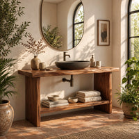 Bathroom vanity with a thick slab top, plank legs and a low shelf in a bright bathroom with arched windows and plants