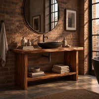 Bathroom vanity with a thick slab top, plank legs and a low shelf in an industrial loft bathroom with exposed brick